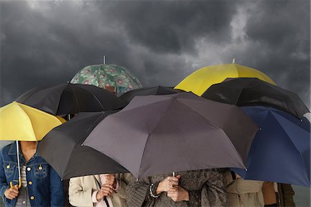 Group of people with umbrellas Stock Photo - Premium Royalty-Free, Code: 614-06311795