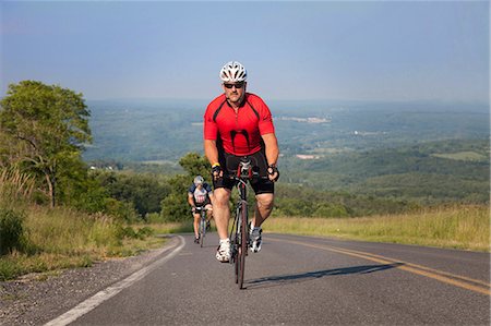 road cycling - Men cycling on open road Stock Photo - Premium Royalty-Free, Code: 614-06311975
