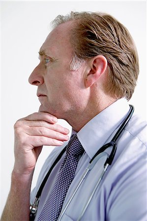 Portrait of doctor with hand on chin Stock Photo - Premium Royalty-Free, Code: 614-06336239