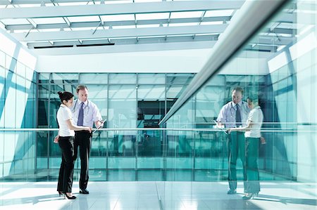 Doctors holding medical records in hospital corridor Stock Photo - Premium Royalty-Free, Code: 614-06336250