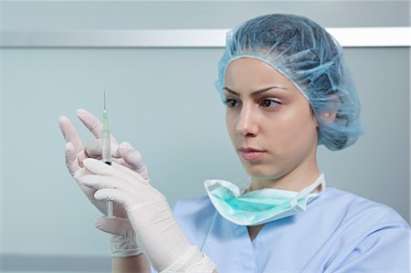 surgical mask - Surgeon holding injection Stock Photo - Premium Royalty-Free, Code: 614-06336271