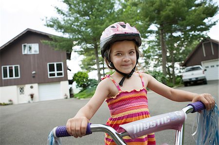 riding on bicycles handle bars - Girl on bicycle Stock Photo - Premium Royalty-Free, Code: 614-06336282