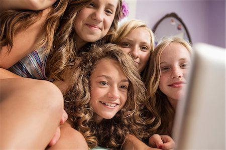 preteen girls in bedroom - Girls looking at digital tablet Stock Photo - Premium Royalty-Free, Code: 614-06402656