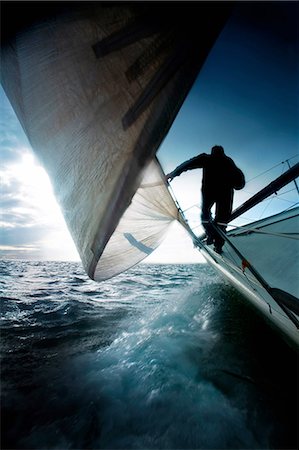 sailing - Silhouette of man on sailing boat Stock Photo - Premium Royalty-Free, Code: 614-06402873