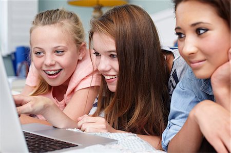 Teenage girls looking at laptop Stock Photo - Premium Royalty-Free, Code: 614-06403081