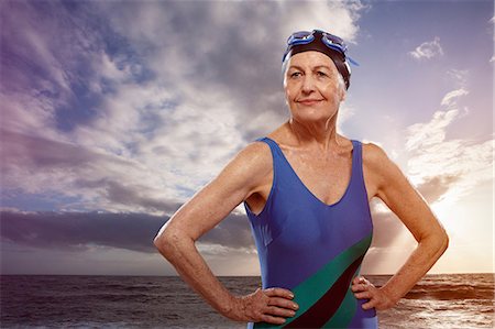 Senior woman wearing swimsuit with hands on hips Stock Photo - Premium Royalty-Free, Code: 614-06442309