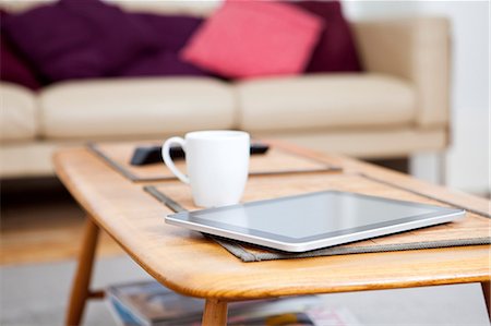 Digital tablet on coffee table Stock Photo - Premium Royalty-Free, Code: 614-06442527