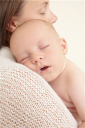 Mother with newborn baby sleeping on shoulder Stock Photo - Premium Royalty-Free, Code: 614-06442841