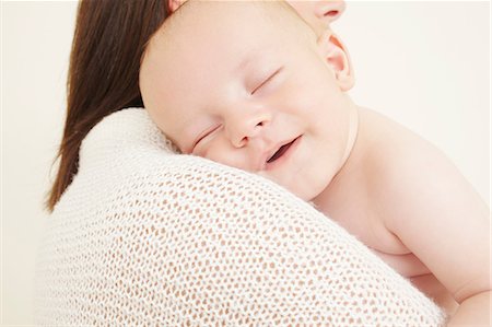 Mother with newborn baby sleeping on shoulder Stock Photo - Premium Royalty-Free, Code: 614-06442843