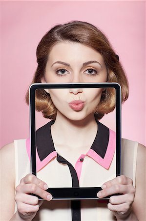 funny people - Woman covering half her face with digital tablet Stock Photo - Premium Royalty-Free, Code: 614-06442903