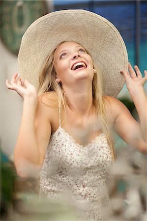 excited young woman - Smiling woman shopping in store Stock Photo - Premium Royalty-Free, Code: 614-06537070