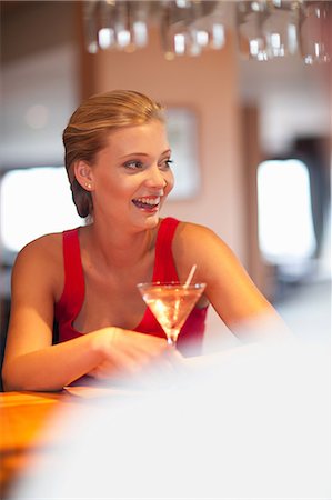 Woman having drink at bar Stock Photo - Premium Royalty-Free, Code: 614-06537209