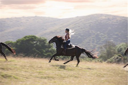 Woman riding horse in rural landscape Fotografie stock - Premium Royalty-Free, Codice: 614-06537220