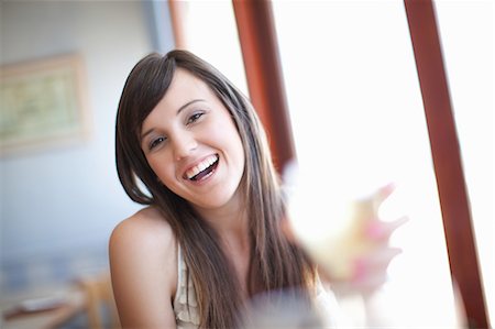 single young woman sitting - Woman having wine in restaurant Stock Photo - Premium Royalty-Free, Code: 614-06537389