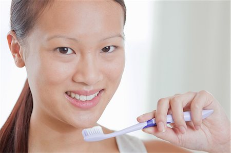 simsearch:614-06536948,k - Woman holding toothbrush in bathroom Stock Photo - Premium Royalty-Free, Code: 614-06537535