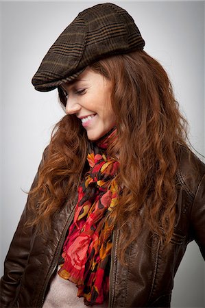 Smiling woman wearing hat and jacket Stock Photo - Premium Royalty-Free, Code: 614-06537550