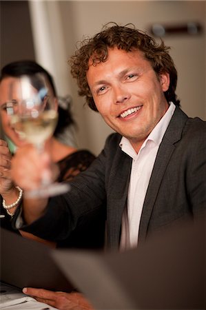 Businessman toasting at dinner table Stock Photo - Premium Royalty-Free, Code: 614-06624013