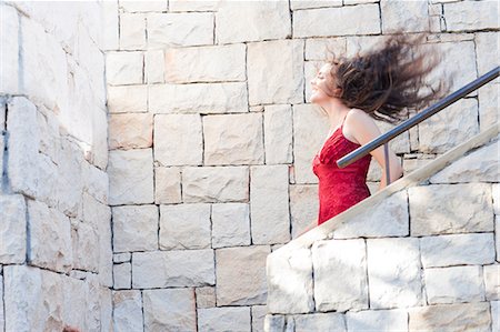 Woman climbing stone steps outdoors Stock Photo - Premium Royalty-Free, Code: 614-06624040