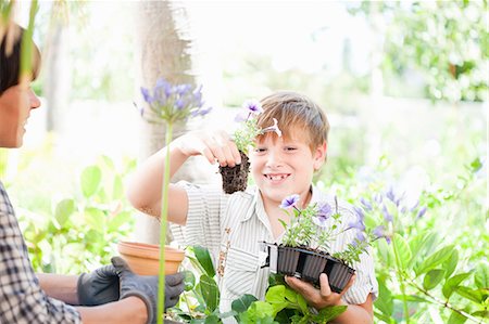 Mother and son potting plants outdoors Stock Photo - Premium Royalty-Free, Code: 614-06624060