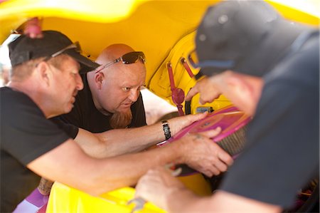 Mechanics working on colorful car Stock Photo - Premium Royalty-Free, Code: 614-06624109