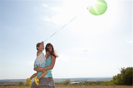 family energy - Mother and daughter carrying balloon Stock Photo - Premium Royalty-Free, Code: 614-06624156