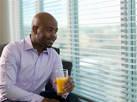 Businessman drinking orange juice Stock Photo - Premium Royalty-Free, Code: 614-06624249