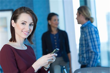 simsearch:614-06537448,k - Businesswoman using cell phone in office Stock Photo - Premium Royalty-Free, Code: 614-06624381