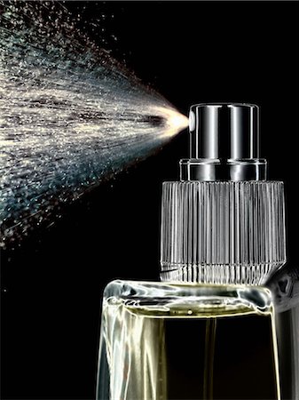 perfume not people - Close up of perfume spraying from bottle Stock Photo - Premium Royalty-Free, Code: 614-06624477