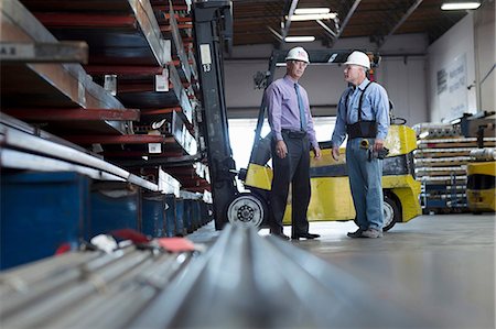 forklift truck - Workers talking in metal plant Stock Photo - Premium Royalty-Free, Code: 614-06624471