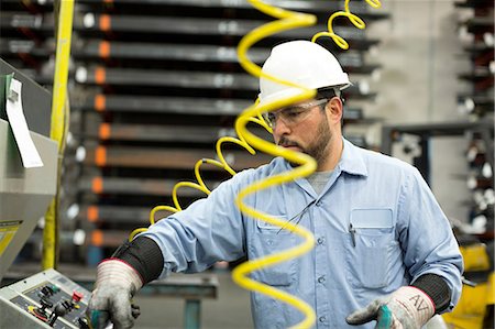 Worker at control panel in metal plant Stock Photo - Premium Royalty-Free, Code: 614-06624524