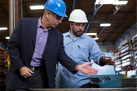 suit talking - Worker and businessman in metal plant Stock Photo - Premium Royalty-Free, Code: 614-06624540