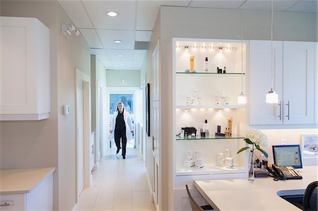 people walking in the distance - Doctor walking in office hallway Stock Photo - Premium Royalty-Free, Code: 614-06624818