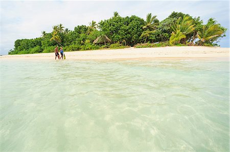 ethnic lover - Couple walking on tropical beach Stock Photo - Premium Royalty-Free, Code: 614-06624856