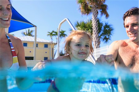 swimming, happy - Parents swimming with toddler in pool Stock Photo - Premium Royalty-Free, Code: 614-06624886