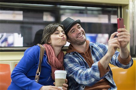 Couple taking picture on subway Stock Photo - Premium Royalty-Free, Code: 614-06624986