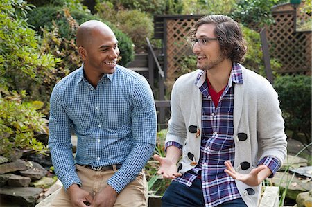 surprise happy - Smiling men talking in backyard Stock Photo - Premium Royalty-Free, Code: 614-06625053