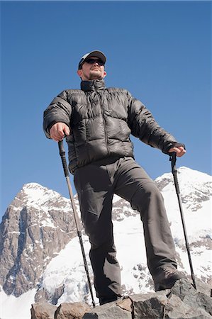 front of hiker - Hiker overlooking snowy mountains Stock Photo - Premium Royalty-Free, Code: 614-06625125