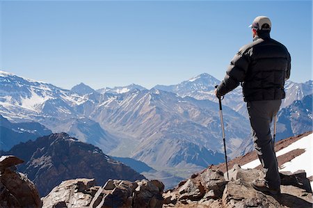 Hiker overlooking snowy mountains Stock Photo - Premium Royalty-Free, Code: 614-06625127