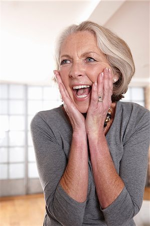 surprise happy - Smiling older woman gasping Stock Photo - Premium Royalty-Free, Code: 614-06625158