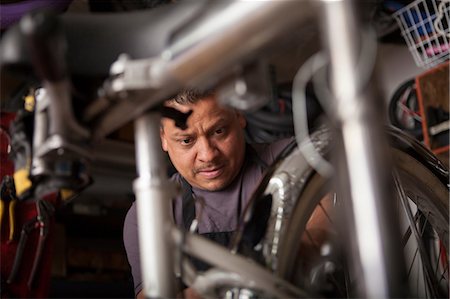 small business man not looking at camera - Mechanic working in bicycle shop Stock Photo - Premium Royalty-Free, Code: 614-06625214