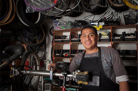 person cruise ship - Mechanic working in bicycle shop Stock Photo - Premium Royalty-Free, Code: 614-06625219