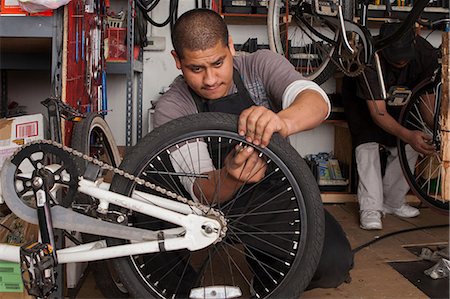 Mechanic working in bicycle shop Stock Photo - Premium Royalty-Free, Code: 614-06625236