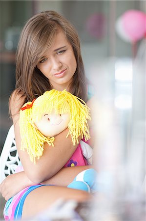 simsearch:695-05780518,k - Sad teenage girl hugging doll Stock Photo - Premium Royalty-Free, Code: 614-06623531