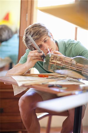 seated on airplane - Man working on model airplane Stock Photo - Premium Royalty-Free, Code: 614-06623556