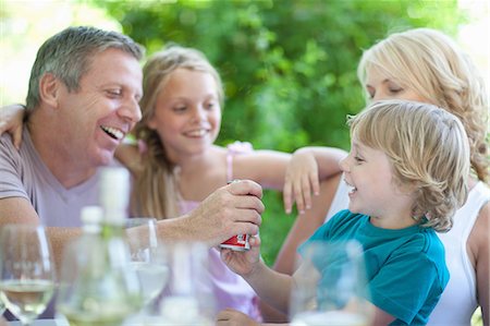 simsearch:614-06623604,k - Father giving son soda at table Stock Photo - Premium Royalty-Free, Code: 614-06623615