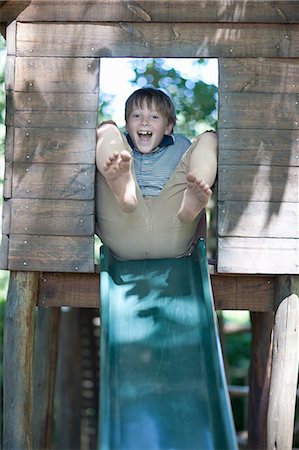 people in playground - Boy playing on slide outdoors Stock Photo - Premium Royalty-Free, Code: 614-06623663