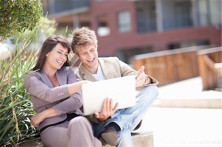 Business people using laptop outdoors Stock Photo - Premium Royalty-Free, Code: 614-06623856