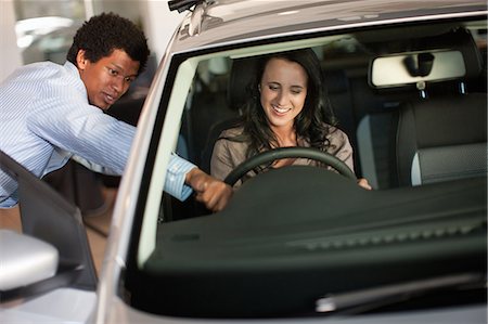 people car shopping - Salesman showing woman new car Stock Photo - Premium Royalty-Free, Code: 614-06623958