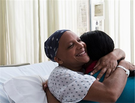 patient care - Daughter hugging mother at hospital Stock Photo - Premium Royalty-Free, Code: 614-06718039