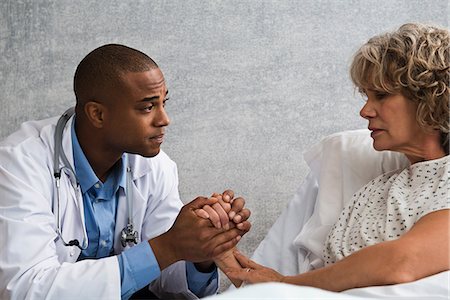 senior woman and doctor and two people - Doctor holding patient's hand Stock Photo - Premium Royalty-Free, Code: 614-06718074